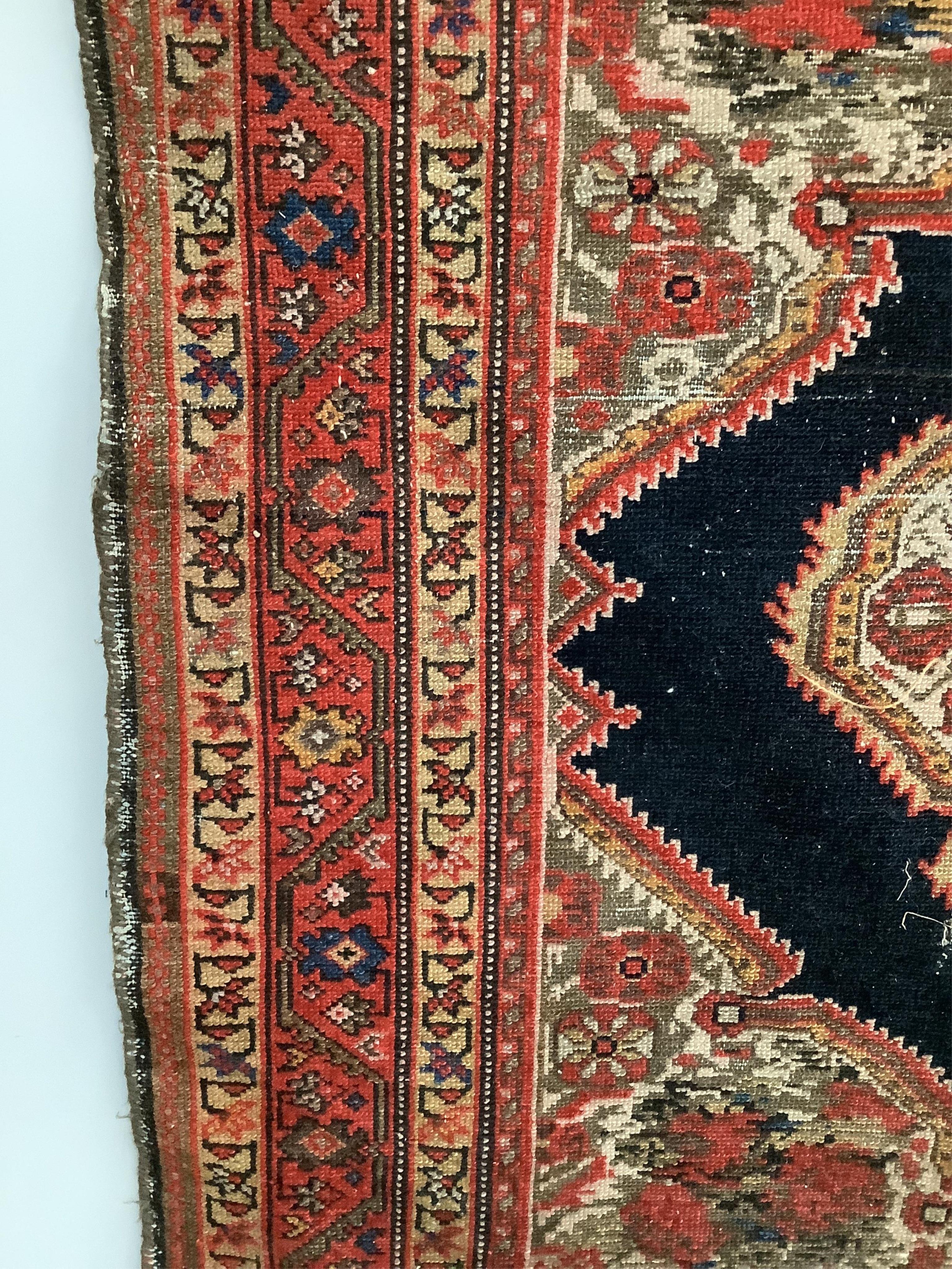 A North West Persian red ground rug, 186 x 120cm. Condition - faded with some wear